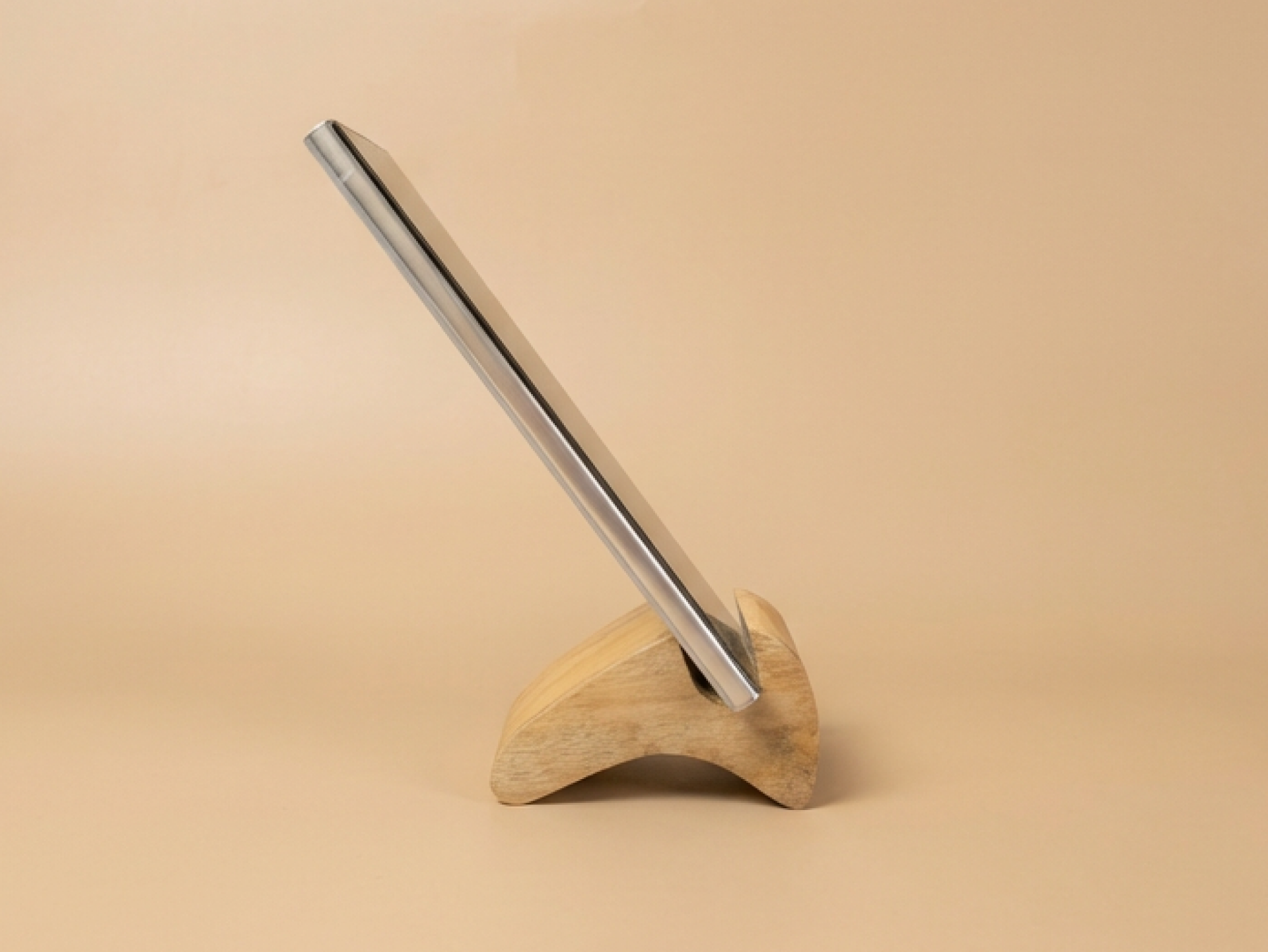 A minimalist wooden phone stand designed for stable, hands-free viewing with a natural, modern aesthetic.