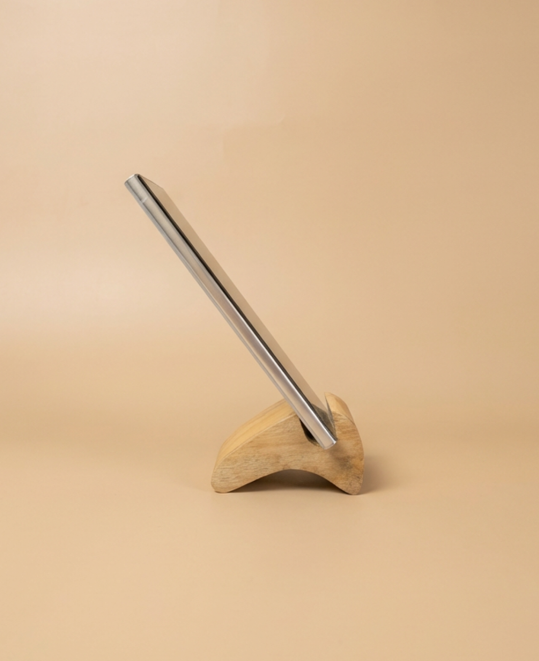 A minimalist wooden phone stand designed for stable, hands-free viewing with a natural, modern aesthetic.