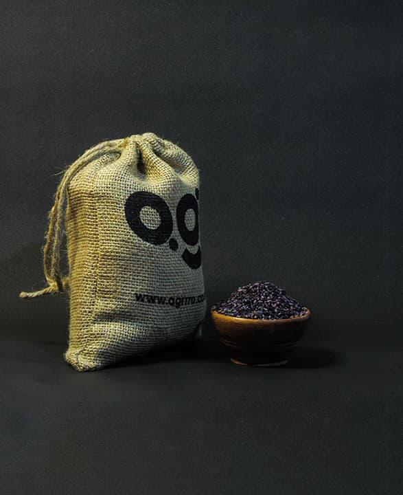 organic black rice also known as purple rice, organic kala chawal, organic rice in a wooden bowl and eco friendly jute packaging on the side filled with organic black rice. Buy best organic black rice in India with plastic free eco friendly packaging now now from agrrro.
