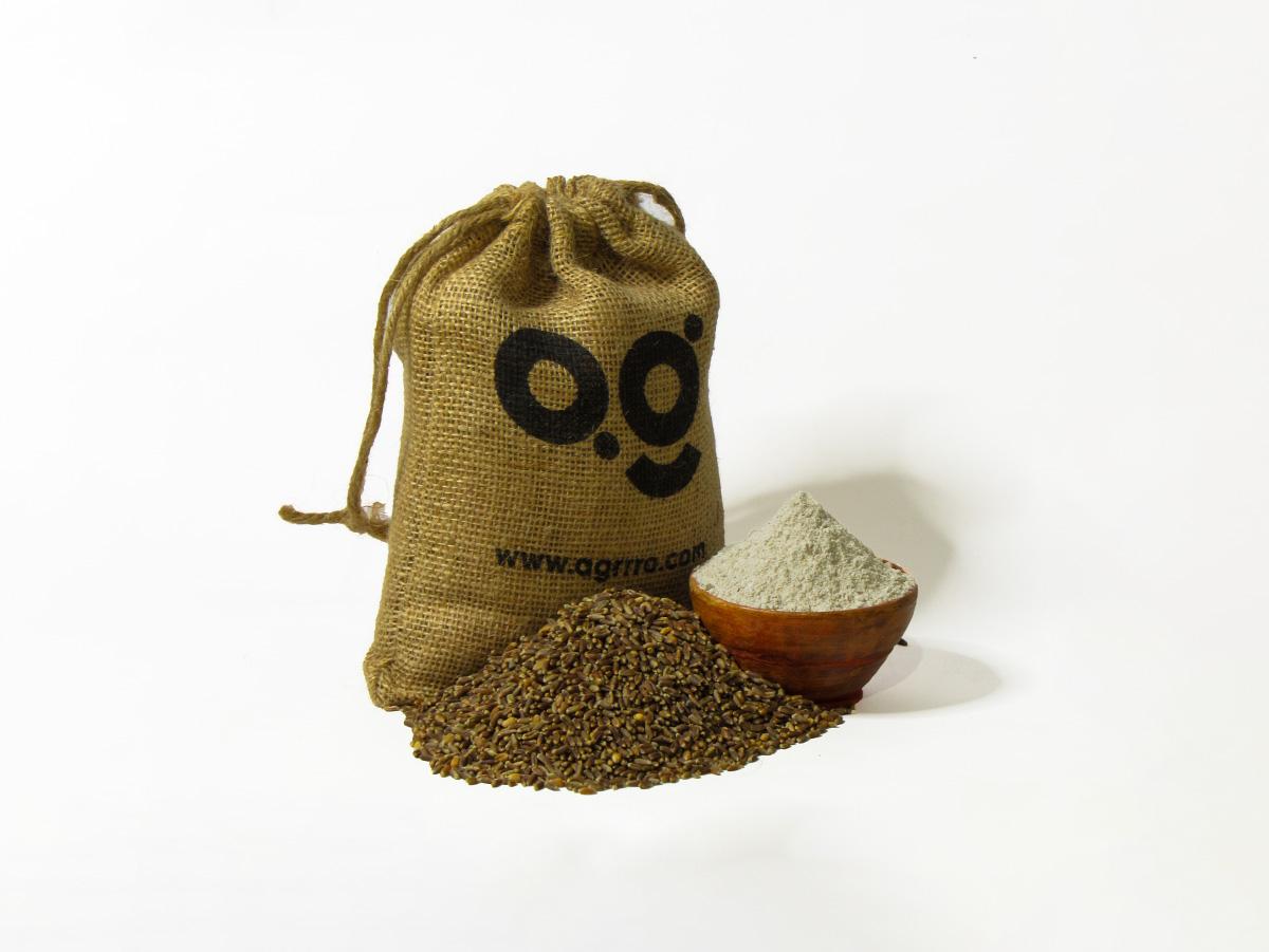 organic black wheat flour also known as organic kala gehu aata, organic wheat flour in a wooden bowl and eco friendly jute packaging on the side filled with organic black wheat flour. Buy best organic black wheat flour in India with plastic free eco friendly packaging now from agrrro.