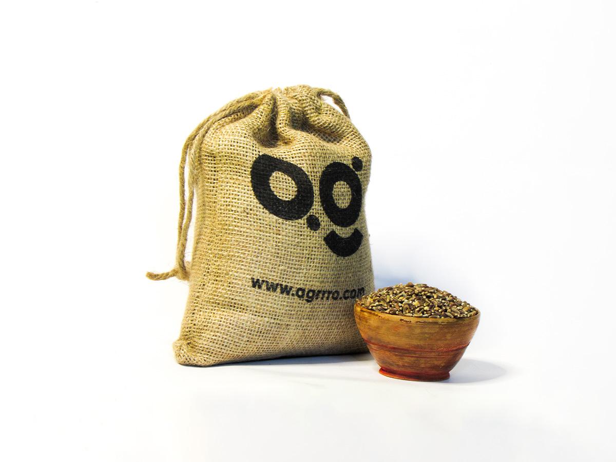 organic black wheat also known as organic kala gehu, organic wheat whole in a wooden bowl and eco friendly jute packaging on the side filled with organic black wheat whole. Buy best organic black wheat whole in India with plastic free eco friendly packaging now from agrrro.