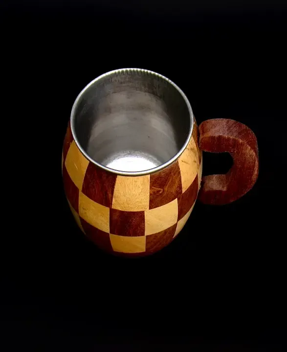 this is the beautiful and best handmade wooden coffee mug with stainless steel inside. It is handcrafted by the best artisans and engraved by hand. It has a checked design to make it beautiful and elegant. By the best handcrafted wooden coffee mug on www.agrrro.com.