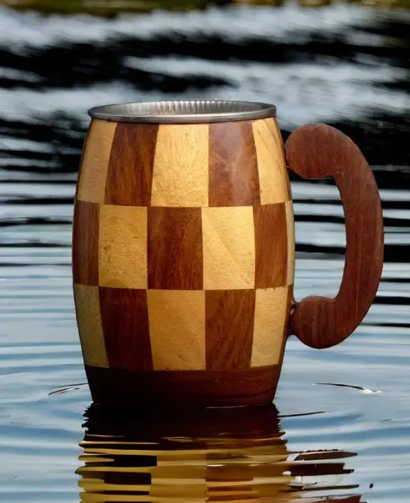 this is the beautiful and best handmade wooden coffee mug with stainless steel inside. It is handcrafted by the best artisans and engraved by hand. It has a checked design to make it beautiful and elegant. By the best handcrafted wooden coffee mug on www.agrrro.com.