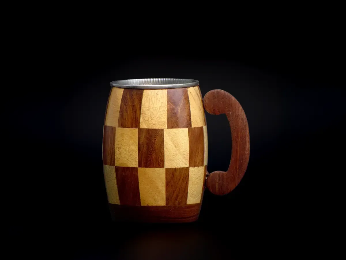 this is the beautiful and best handmade wooden coffee mug with stainless steel inside. It is handcrafted by the best artisans and engraved by hand. It has a checked design to make it beautiful and elegant. By the best handcrafted wooden coffee mug on www.agrrro.com.