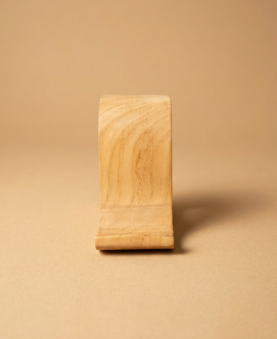 A handcrafted wooden bird-shaped phone stand that blends functionality with minimalist decor.